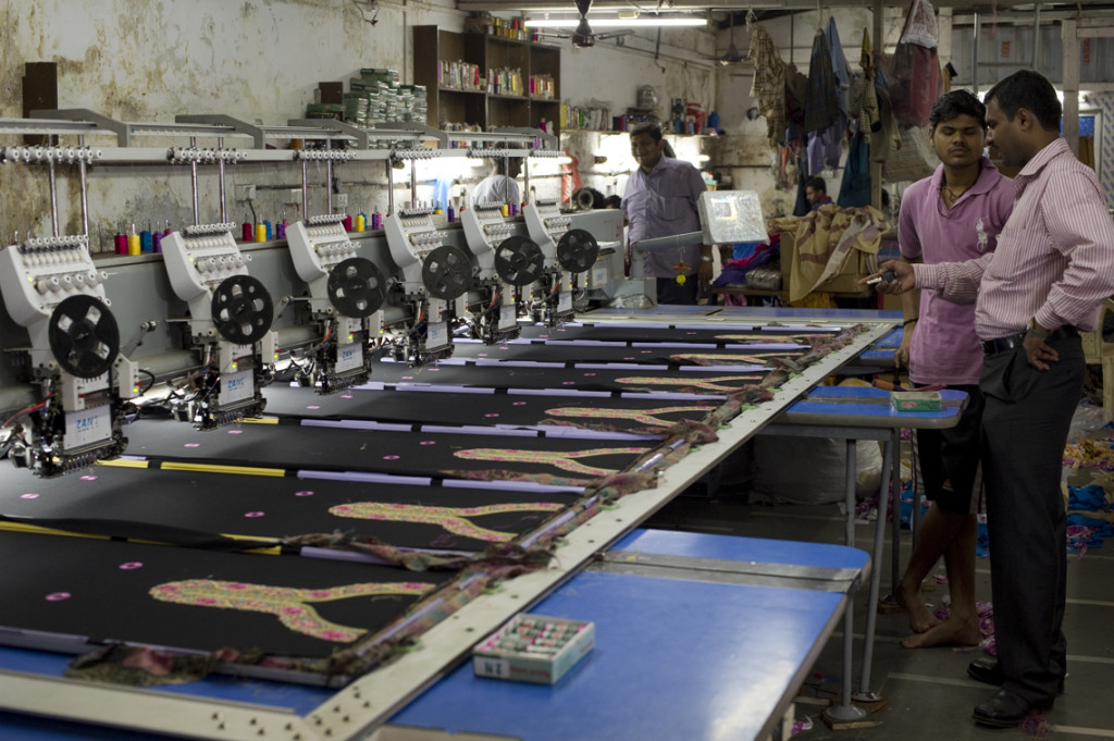 Workers supervise an embroidery unit at a textile mill in Dharavi, Mumbai.